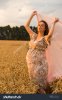 beautiful-young-pregnant-woman-in-a-dress-middle-of-wheat-field-342050564.jpg