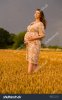 pregnant-woman-in-a-wheat-field-happy-woman-in-the-field-313529648.jpg