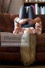 648-05651140em-woman-laying-upsidedown-on-sofa-text-messaging-on-cell-phone-stock.jpg