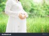 stock-photo-pregnant-woman-carry-her-belly-with-love-sign-and-care-in-fresh-garden-529623319.jpg