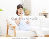 smiling-pregnant-japanese-woman-450w-563644825.jpg