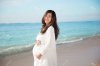 45151211-happy-asian-pregnant-woman-smile-while-touching-her-tummy-on-the-beach.jpg