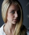 13644584-young-adult-caucasian-woman-with-long-blonde-hair-and-green-eyes-wearing-a-plain-whit...jpg