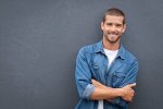 127284879-portrait-of-handsome-young-man-in-casual-denim-shirt-keeping-arms-crossed-and-smilin...jpg