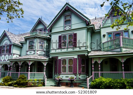 stock-photo-beautiful-big-old-nostalgic-historic-wooden-green-with-purple-victorian-house-building-with-porch-52301809.jpg