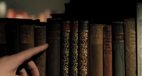 finger-passes-along-book-spines-library-animated-gif.gif