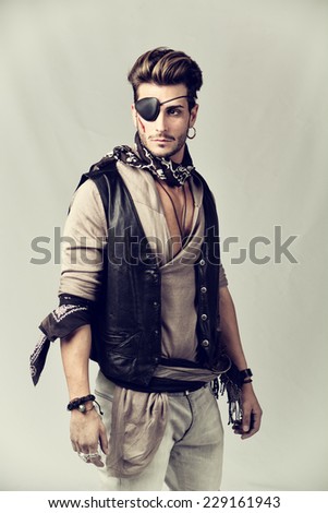 stock-photo-good-looking-young-man-in-pirate-fashion-outfit-on-gray-background-captured-in-studio-229161943.jpg
