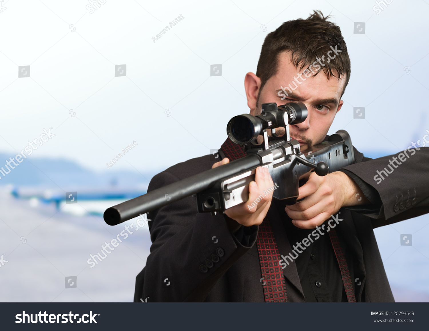 stock-photo-young-man-aiming-with-rifle-at-a-port-120793549.jpg