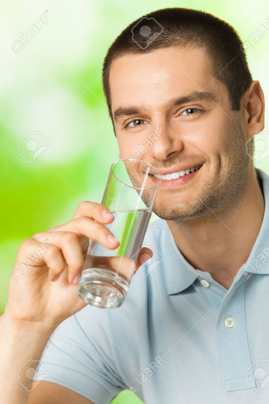 8421152-Young-happy-smiling-man-drinking-water-outdoors-Stock-Photo.jpg