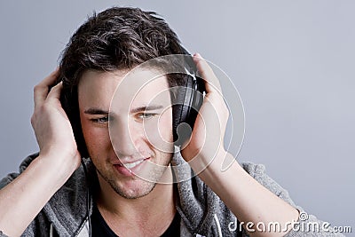 guy-holding-headphones-8052130.jpg