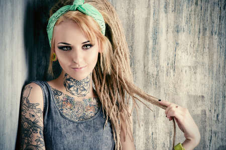 36991700-sexual-blonde-girl-with-fascinating-dreadlocks-posing-by-the-grunge-wall-pin-up-style.jpg