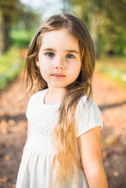 portrait-cute-little-girl-with-long-hair-standing-park_23-2147893135.jpg