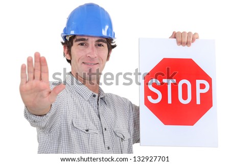 stock-photo-builder-holding-stop-sign-132927701.jpg