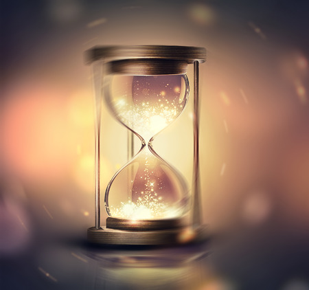 102619708-hourglass-with-shining-light-on-dark-background-with-soft-bokeh-effect-3d-image.jpg